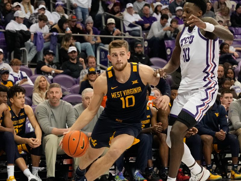 Jan 31, 2023; Fort Worth, Texas, USA; West Virginia Mountaineers guard Erik Stevenson (10) drives to the basket past TCU Horned Frogs guard Damion Baugh (10) during the second half at Ed and Rae Schollmaier Arena. Mandatory Credit: Chris Jones-USA TODAY Sports