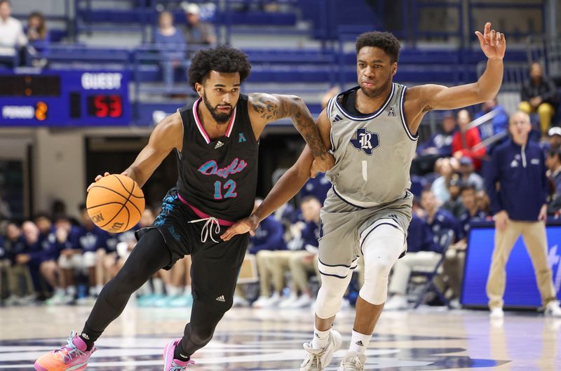 Jan 24, 2024; Houston, Texas, USA; Rice Owls guard Noah Shelby (1) defends against Florida Atlantic Owls guard Jalen Gaffney (12) during the second half at Tudor Fieldhouse. Mandatory Credit: Troy Taormina-USA TODAY Sports