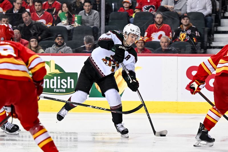 Jan 16, 2024; Calgary, Alberta, CAN; Arizona Coyotes right wing Clayton Keller (9) takes a shot on net against the Calgary Flames during the second period at Scotiabank Saddledome. Mandatory Credit: Brett Holmes-USA TODAY Sports