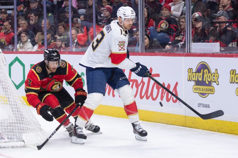 Jan 10, 2026; Ottawa, Ontario, CAN; Florida Panthers center Sam Reinhart (13) moves the puck away from Ottawa Senators defenseman Nick Jensen (3) in the second period at the Canadian Tire Centre. Mandatory Credit: Marc DesRosiers-IMAGN Images