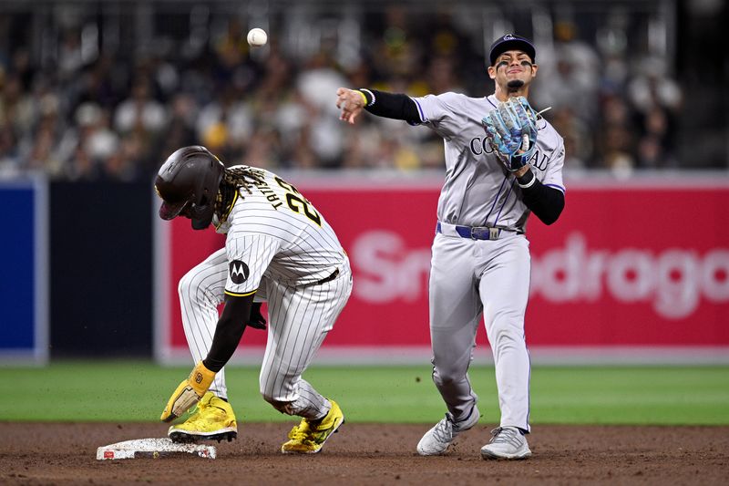 May 13, 2024; San Diego, California, USA; Colorado Rockies shortstop Ezequiel Tovar (14) throws to first base late after forcing out San Diego Padres right fielder Fernando Tatis Jr. (23) at second base during the seventh inning at Petco Park. Mandatory Credit: Orlando Ramirez-USA TODAY Sports