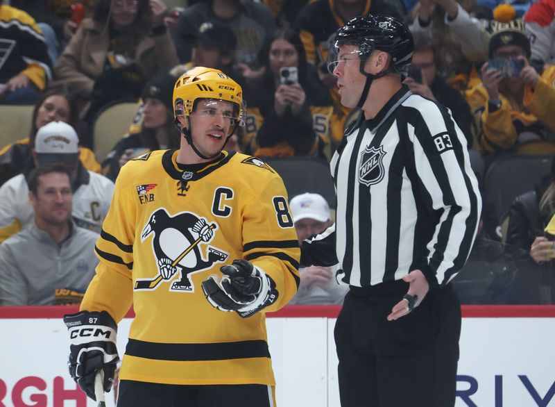 Nov 6, 2025; Pittsburgh, Pennsylvania, USA;  Pittsburgh Penguins center Sidney Crosby (87) talks with linesman Matt MacPherson (83) against the Washington Capitals during the first period at PPG Paints Arena. Mandatory Credit: Charles LeClaire-Imagn Images