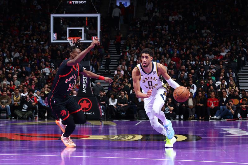 TORONTO, CANADA - DECEMBER 3: Tyrese Haliburton #0 of the Indiana Pacers handles the ball during the game against the Toronto Raptors during the Emirates NBA Cup game on December 3, 2024 at the Scotiabank Arena in Toronto, Ontario, Canada.  NOTE TO USER: User expressly acknowledges and agrees that, by downloading and or using this Photograph, user is consenting to the terms and conditions of the Getty Images License Agreement.  Mandatory Copyright Notice: Copyright 2024 NBAE (Photo by Vaughn Ridley/NBAE via Getty Images)