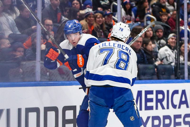 Feb 24, 2024; Elmont, New York, USA;  New York Islanders defenseman Noah Dobson (8) is checked into the glass by Tampa Bay Lightning defenseman Emil Martinsen Lilleberg (78) in the third period at UBS Arena. Mandatory Credit: Wendell Cruz-USA TODAY Sports