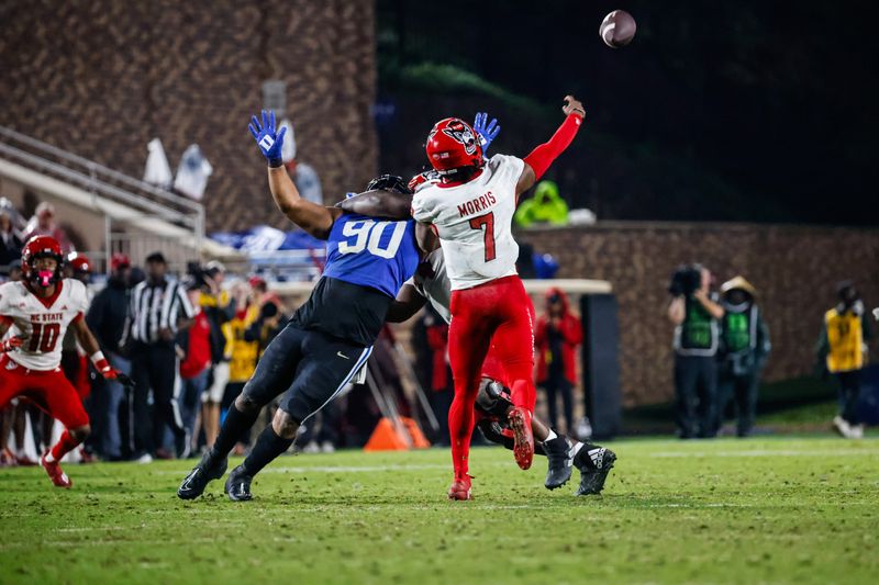 Oct 14, 2023; Durham, North Carolina, USA; North Carolina State Wolfpack tight end Cedd Seabrough (14) is charged with holding against Duke Blue Devils defensive tackle DeWayne Carter (90) while quarterback MJ Morris (7) throws the ball during the second half of the game at Wallace Wade Stadium. Mandatory Credit: Jaylynn Nash-USA TODAY Sports