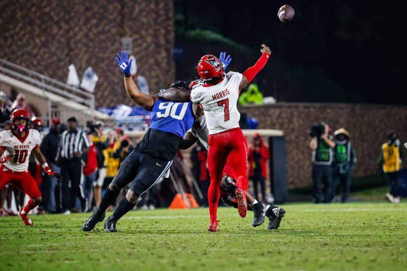 Oct 14, 2023; Durham, North Carolina, USA; North Carolina State Wolfpack tight end Cedd Seabrough (14) is charged with holding against Duke Blue Devils defensive tackle DeWayne Carter (90) while quarterback MJ Morris (7) throws the ball during the second half of the game at Wallace Wade Stadium. Mandatory Credit: Jaylynn Nash-USA TODAY Sports