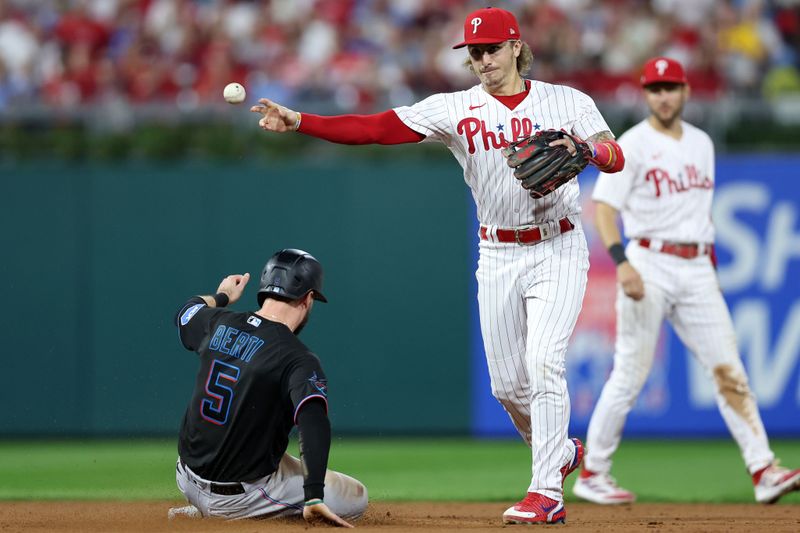 Oct 4, 2023; Philadelphia, Pennsylvania, USA; Philadelphia Phillies second baseman Bryson Stott (5) gets the double play on Miami Marlins shortstop Jon Berti (5) during the sixth inning for game two of the Wildcard series for the 2023 MLB playoffs at Citizens Bank Park. Mandatory Credit: Bill Streicher-USA TODAY Sports