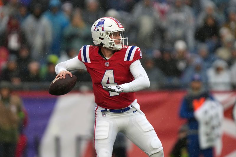 New England Patriots quarterback Bailey Zappe (4) looks to pass during the first half of an NFL football game against the Los Angeles Chargers, Sunday, Dec. 3, 2023, in Foxborough, Mass. (AP Photo/Steven Senne)