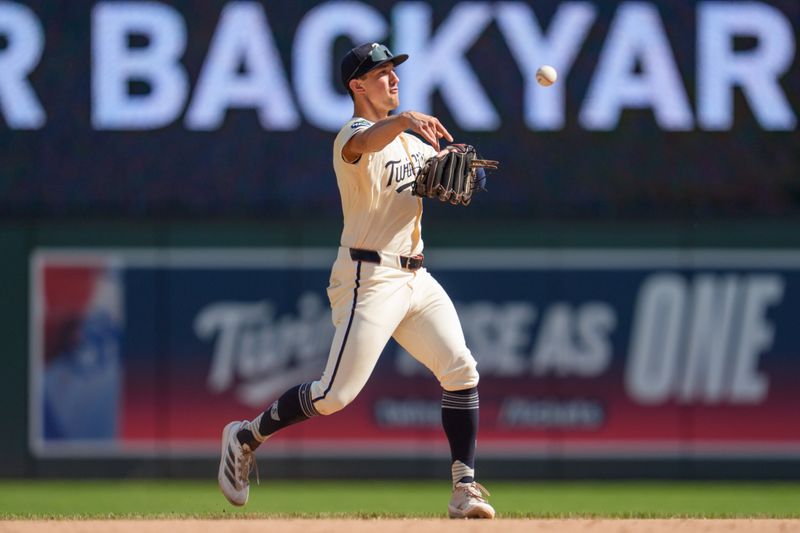 Sep 14, 2025; Minneapolis, Minnesota, USA; Minnesota Twins shortstop Brooks Lee (2) throws out Arizona Diamondbacks right fielder Corbin Carroll (7) in the sixth inning at Target Field. Mandatory Credit: Matt Blewett-Imagn Images