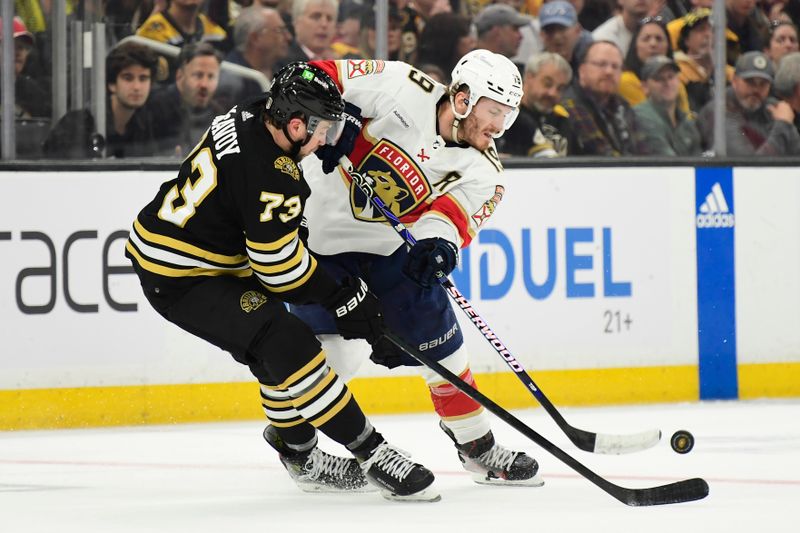 May 17, 2024; Boston, Massachusetts, USA; Boston Bruins defenseman Charlie McAvoy (73) and Florida Panthers left wing Matthew Tkachuk (19) battle for the puck during the second period in game six of the second round of the 2024 Stanley Cup Playoffs at TD Garden. Mandatory Credit: Bob DeChiara-USA TODAY Sports