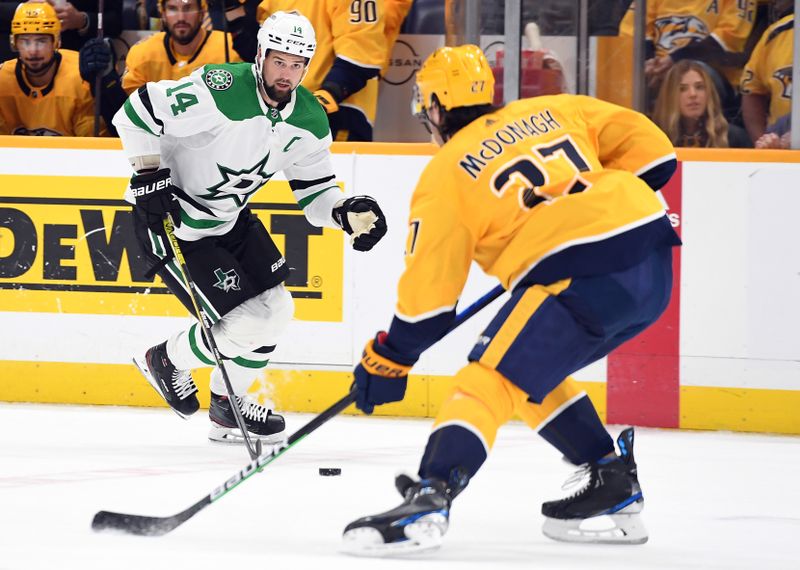 Oct 13, 2022; Nashville, Tennessee, USA; Dallas Stars left wing Jamie Benn (14) skates with the puck against Nashville Predators defenseman Ryan McDonagh (27) during the second period at Bridgestone Arena. Mandatory Credit: Christopher Hanewinckel-USA TODAY Sports