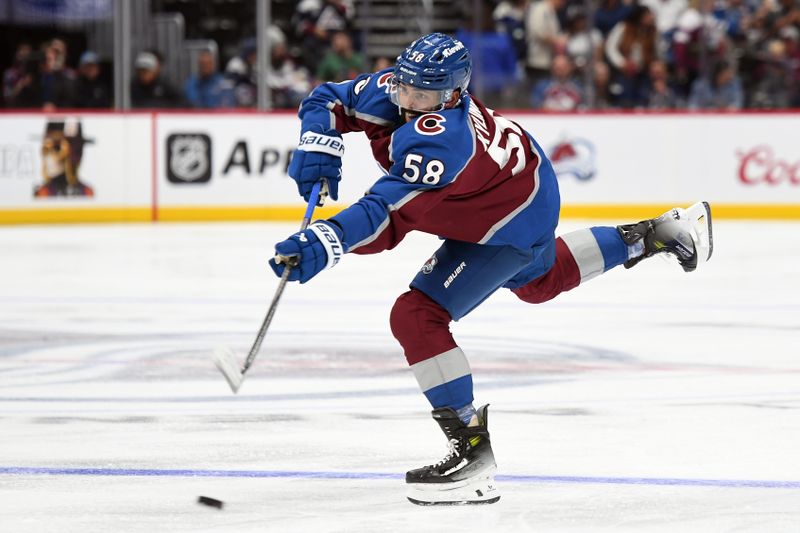 Sep 29, 2024; Denver, Colorado, USA; Colorado Avalanche defenseman Oliver Kylington (58) shoots the puck during the second period against the Utah Hockey Club at Ball Arena. Mandatory Credit: Christopher Hanewinckel-Imagn Images