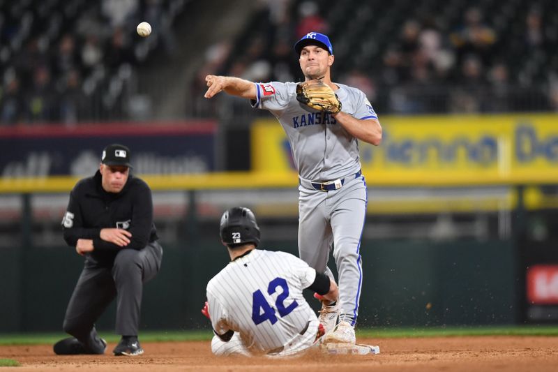 Apr 15, 2024; Chicago, Illinois, USA; Kansas City Royals second baseman Adam Frazier (26) completes a double play after forcing out Chicago White Sox left fielder Andrew Benintendi (23) during the sixth inning at Guaranteed Rate Field. Mandatory Credit: Patrick Gorski-USA TODAY Sports