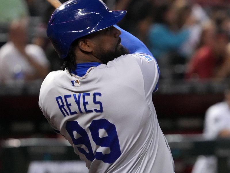 Apr 25, 2023; Phoenix, Arizona, USA; Kansas City Royals designated hitter Franmil Reyes (99) hits a sacrifice fly RBI against the Arizona Diamondbacks during the fifth inning at Chase Field. Mandatory Credit: Joe Camporeale-USA TODAY Sports