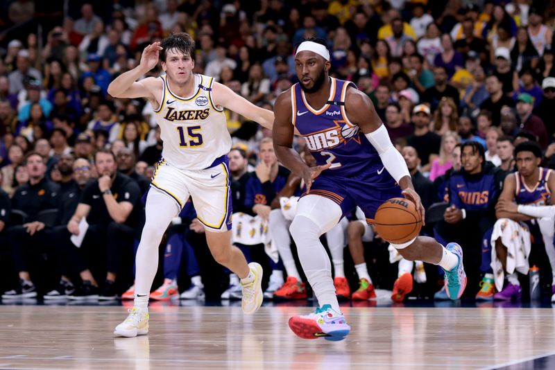 PALM SPRINGS, CALIFORNIA - OCTOBER 06: Josh Okogie #2 of the Phoenix Suns drives past Austin Reaves #15 of the Los Angeles Lakers during the second quarter  at Acrisure Arena on October 06, 2024 in Palm Springs, California. NOTE TO USER: User expressly acknowledges and agrees that, by downloading and/or using this photograph, user is consenting to the terms and conditions of the Getty Images License Agreement. (Photo by Katelyn Mulcahy/Getty Images)