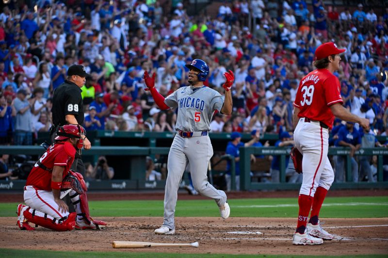 May 25, 2024; St. Louis, Missouri, USA;  Chicago Cubs designated hitter Christopher Morel (5) reacts as he scores as St. Louis Cardinals catcher Ivan Herrera (48) and starting pitcher Miles Mikolas (39) looks on during the fourth inning at Busch Stadium. Mandatory Credit: Jeff Curry-USA TODAY Sports