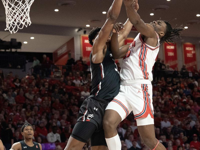 Jan 28, 2023; Houston, Texas, USA; Houston Cougars forward Jarace Walker (25) shoots against Cincinnati Bearcats guard Mika Adams-Woods (3) in the first half at Fertitta Center. Mandatory Credit: Thomas Shea-USA TODAY Sports