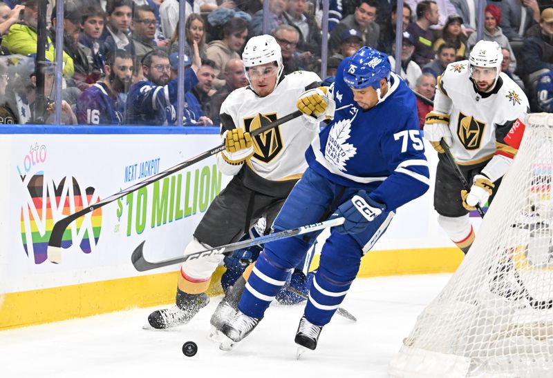 Feb 27, 2024; Toronto, Ontario, CAN;  Toronto Maple Leafs forward Ryan Reaves (75) battles for the puck with Vegas Golden Knights defenseman Zach Whitecloud (2) in the first period at Scotiabank Arena. Mandatory Credit: Dan Hamilton-USA TODAY Sports