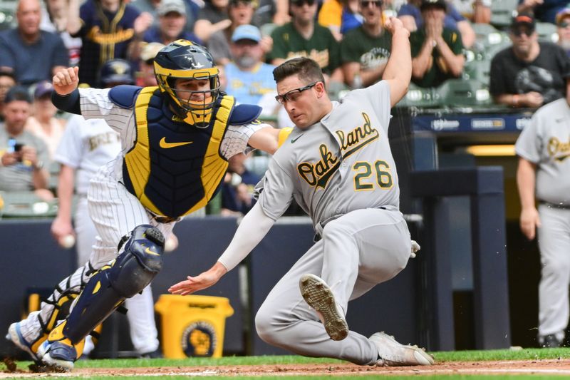 Jun 10, 2023; Milwaukee, Wisconsin, USA; Milwaukee Brewers catcher Victor Caratini (7) tags out Oakland Athletes third baseman Jonah Bride (26) in the second inning at American Family Field. Mandatory Credit: Benny Sieu-USA TODAY Sports