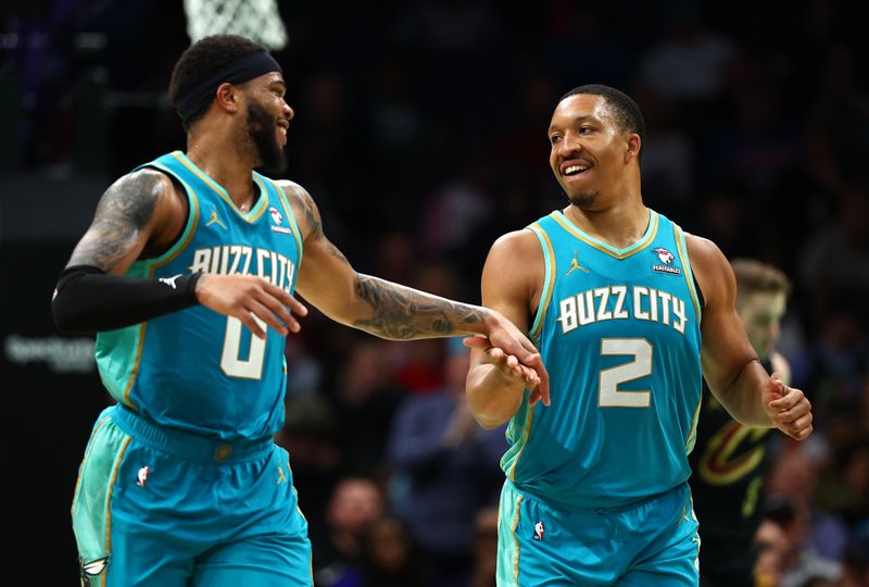 CHARLOTTE, NORTH CAROLINA - MARCH 27: Grant Williams #2 and Miles Bridges #0 of the Charlotte Hornets react during the second half of the game against the Cleveland Cavaliers at Spectrum Center on March 27, 2024 in Charlotte, North Carolina. NOTE TO USER: User expressly acknowledges and agrees that, by downloading and or using this photograph, User is consenting to the terms and conditions of the Getty Images License Agreement. (Photo by Jared C. Tilton/Getty Images)