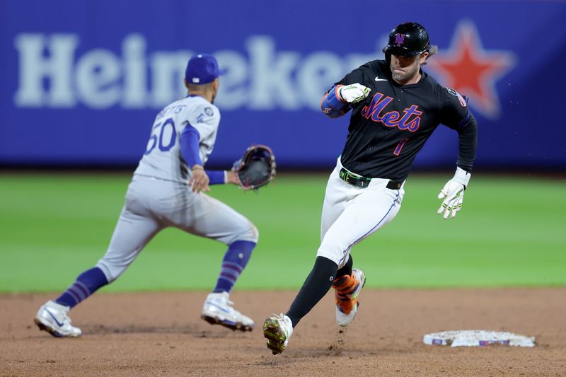 May 23, 2025; New York City, New York, USA; New York Mets second baseman Jeff McNeil (1) rounds second base in front of Los Angeles Dodgers shortstop Mookie Betts (50) as he runs out his two run triple during the ninth inning at Citi Field. Mandatory Credit: Brad Penner-Imagn Images