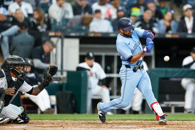 May 27, 2024; Chicago, Illinois, USA; Toronto Blue Jays third baseman Isiah Kiner-Falefa (7) hits an RBI-single against the Chicago White Sox during the fourth inning at Guaranteed Rate Field. Mandatory Credit: Kamil Krzaczynski-USA TODAY Sports