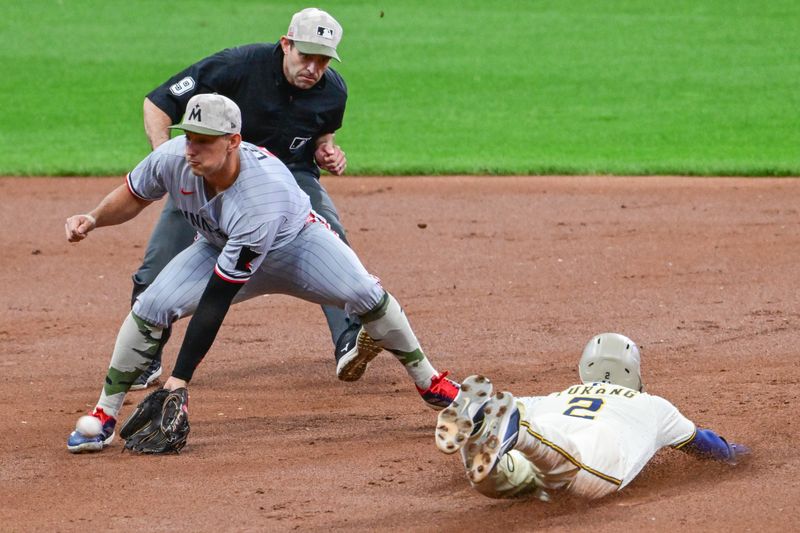 May 17, 2025; Milwaukee, Wisconsin, USA;  Milwaukee Brewers second baseman Brice Turang (2) steals second base before tag by Minnesota Twins shortstop Brooks Lee (2) in the first inning at American Family Field. Mandatory Credit: Benny Sieu-Imagn Images