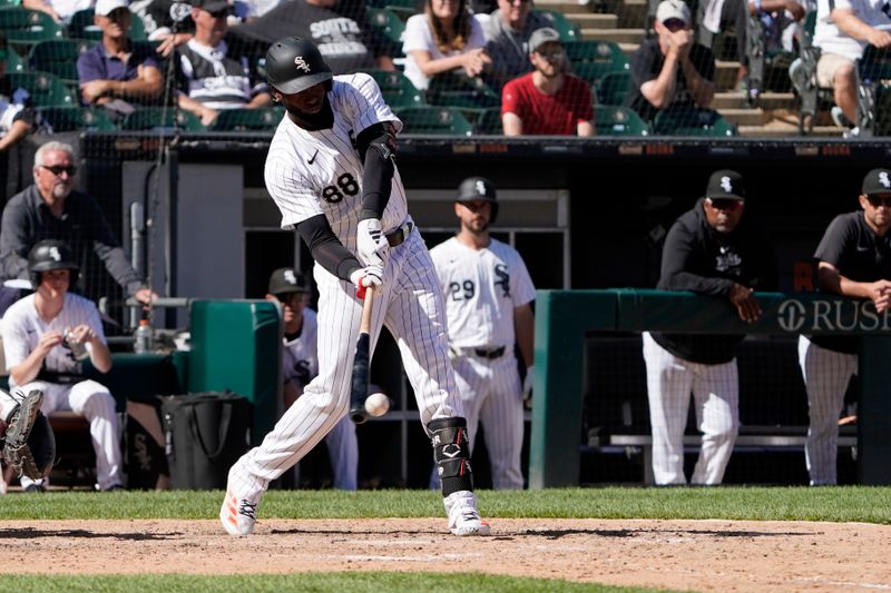 Jun 30, 2024; Chicago, Illinois, USA; Chicago White Sox outfielder Luis Robert Jr. (88) hits a single against the Colorado Rockies during the thirteenth inning at Guaranteed Rate Field. Mandatory Credit: David Banks-USA TODAY Sports