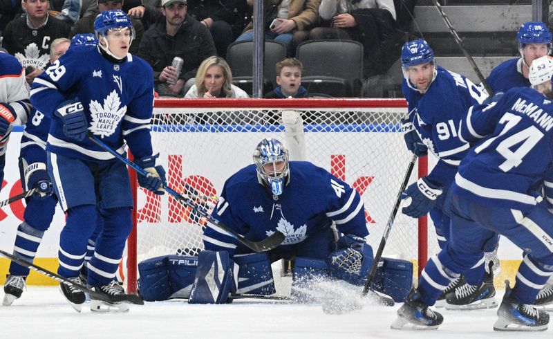 Nov 16, 2024; Toronto, Ontario, CAN;  Toronto Maple Leafs goalie Anthony Stolarz (41) defends his goal with forward Pontus Holmberg (29) and forward John Tavares (91) in the third period at Scotiabank Arena. Mandatory Credit: Dan Hamilton-Imagn Images