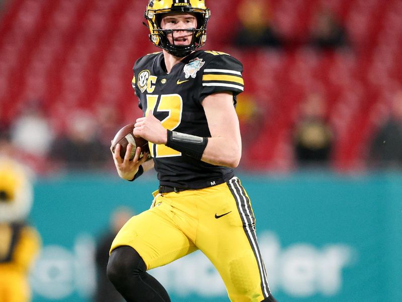 Dec 23, 2022; Tampa, Florida, USA; Missouri Tigers quarterback Brady Cook (12)runs with the ball against the Wake Forest Demon Deacons in the third quarter in the 2022 Gasparilla Bowl at Raymond James Stadium. Mandatory Credit: Nathan Ray Seebeck-USA TODAY Sports