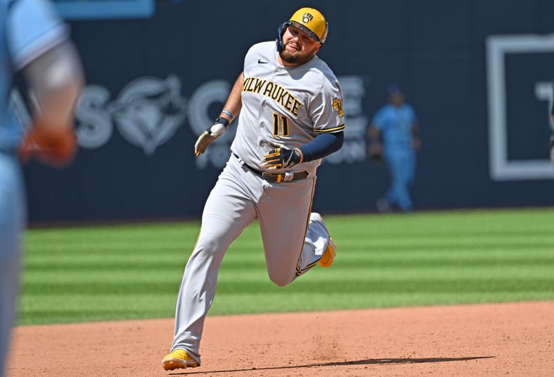 Jun 1, 2023; Toronto, Ontario, CAN;  Milwaukee Brewers first baseman Rowdy Tellez (11) rounds the bases after hitting a triple against the Toronto Blue Jays in the ninth  inning at Rogers Centre. Mandatory Credit: Dan Hamilton-USA TODAY Sports