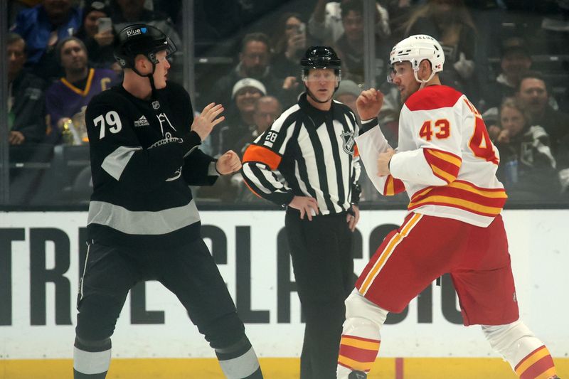 Dec 13, 2025; Los Angeles, California, USA;  Los Angeles Kings center Samuel Helenius (79) and Calgary Flames right wing Adam Klapka (43) fight during the first period at Crypto.com Arena. Mandatory Credit: Kiyoshi Mio-Imagn Images