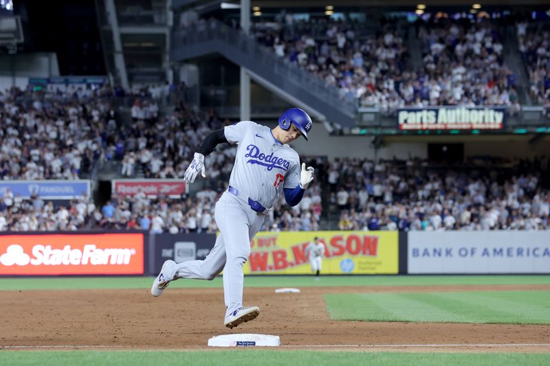 Jun 7, 2024; Bronx, New York, USA; Los Angeles Dodgers designated hitter Shohei Ohtani (17) rounds third base and scores against the New York Yankees on a double by left fielder Teoscar Hernandez (not pictured) during the eleventh inning at Yankee Stadium. Mandatory Credit: Brad Penner-USA TODAY Sports