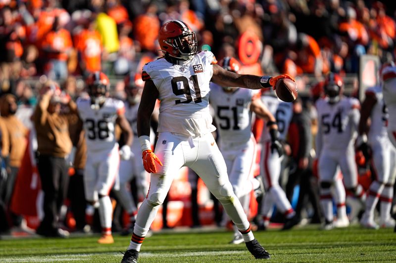 Cleveland Browns defensive end Alex Wright (91) celebrates a fumble recovery by the Browns during the first half of an NFL football game against the Denver Broncos on Sunday, Nov. 26, 2023, in Denver. (AP Photo/Jack Dempsey)