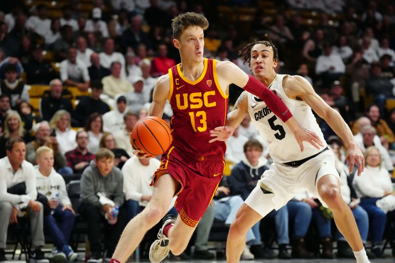 Feb 23, 2023; Boulder, Colorado, USA; USC Trojans guard Drew Peterson (13) drives past Colorado Buffaloes guard Quincy Allen (5) in the second half at the CU Events Center. Mandatory Credit: Ron Chenoy-USA TODAY Sports