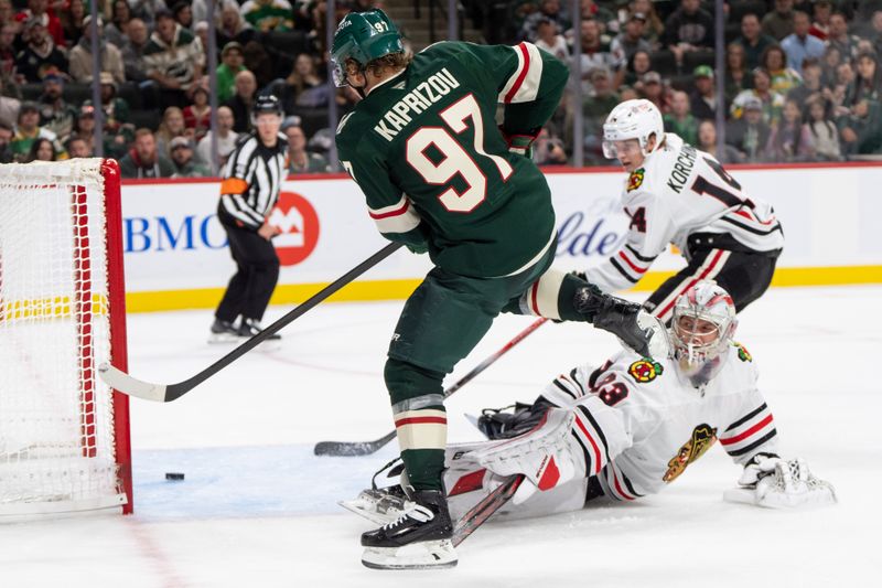 Oct 1, 2024; Saint Paul, Minnesota, USA; Minnesota Wild left wing Kirill Kaprizov (97) beats Chicago Blackhawks goaltender Drew Commesso (33) but the puck does not go in the goal in the second period at Xcel Energy Center. Mandatory Credit: Matt Blewett-Imagn Images