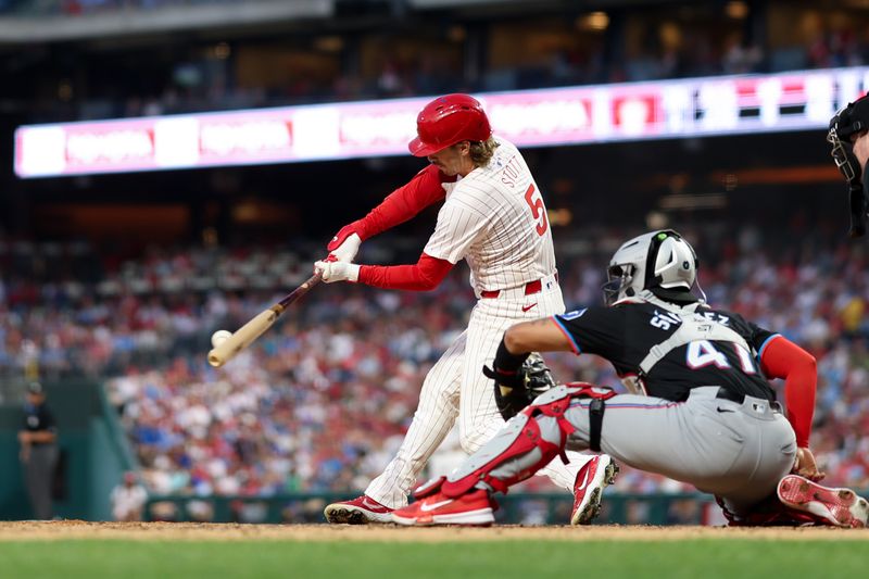 Aug 14, 2024; Philadelphia, Pennsylvania, USA; Philadelphia Phillies second base Bryson Stott (5) hits a single during the fourth inning against the Miami Marlins at Citizens Bank Park. Mandatory Credit: Bill Streicher-USA TODAY Sports