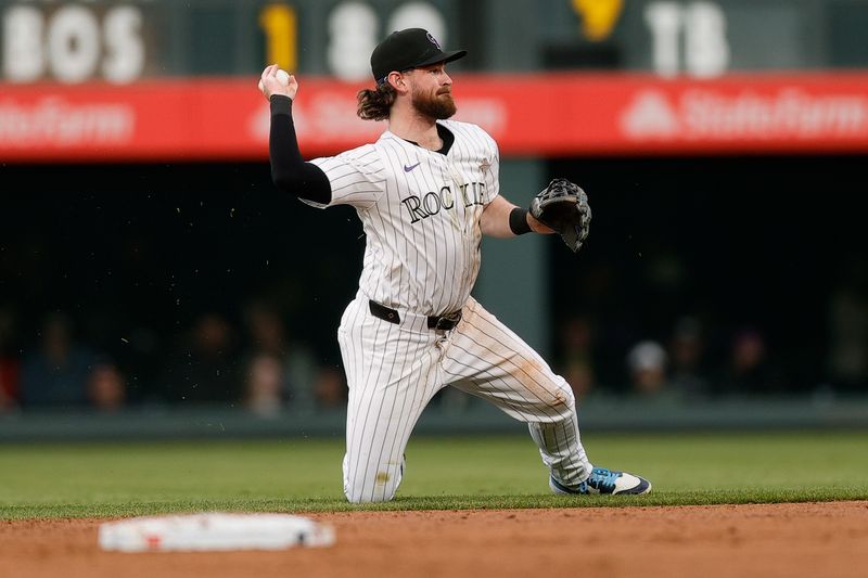 May 10, 2024; Denver, Colorado, USA; Colorado Rockies second baseman Brendan Rodgers (7) makes a throw from the turf in the third inning against the Texas Rangers at Coors Field. Mandatory Credit: Isaiah J. Downing-USA TODAY Sports