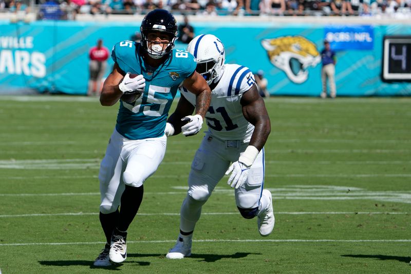 Jacksonville Jaguars tight end Brenton Strange (85) runs past Indianapolis Colts defensive end Kwity Paye (51) after a catch during the first half of an NFL football game, Sunday, Oct. 15, 2023, in Jacksonville, Fla. (AP Photo/John Raoux)