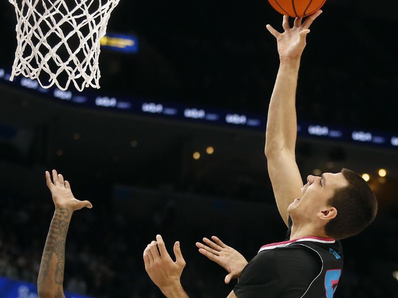 Feb 25, 2024; Memphis, Tennessee, USA; Florida Atlantic Owls center Vladislav Goldin (50) shoots over Memphis Tigers guard Jaykwon Walton (10) during the second half at FedExForum. Mandatory Credit: Petre Thomas-USA TODAY Sports