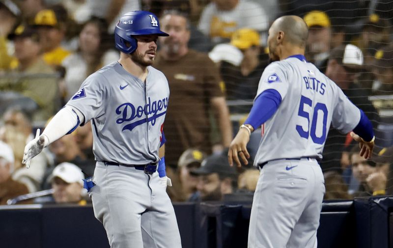 Oct 9, 2024; San Diego, California, USA; Los Angeles Dodgers second baseman Gavin Lux (9) celebrates with shortstop Mookie Betts (50) after hitting a two-run home run in the seventh inning against the San Diego Padres during game four of the NLDS for the 2024 MLB Playoffs at Petco Park. Mandatory Credit: David Frerker-Imagn Images