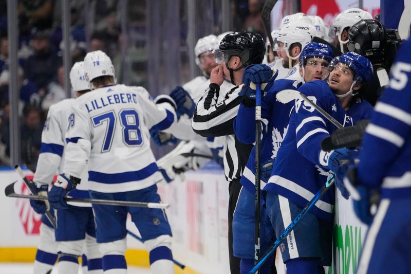 Apr 3, 2024; Toronto, Ontario, CAN; Toronto Maple Leafs forward Nicholas Robertson (89) looks up at the scoreboard as Tampa Bay Lightning celebrate a goal by forward Nicholas Paul (not pictured) during the third period at Scotiabank Arena. Mandatory Credit: John E. Sokolowski-USA TODAY Sports