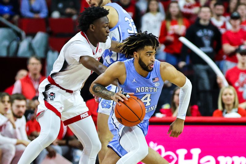 Feb 19, 2023; Raleigh, North Carolina, USA;  North Carolina Tar Heels guard R.J. Davis (4) drives during the first half of the game against North Carolina State Wolfpack at PNC Arena. Mandatory Credit: Jaylynn Nash-USA TODAY Sports