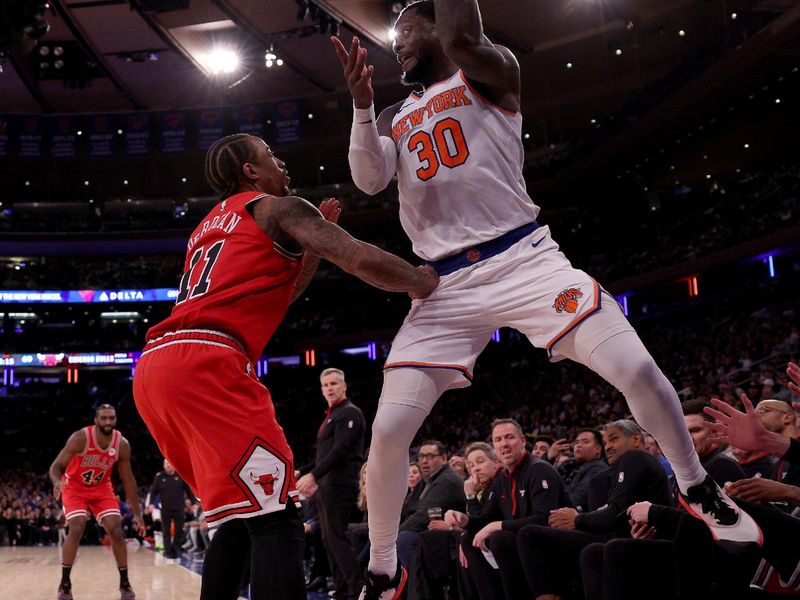 NEW YORK, NEW YORK - JANUARY 03: Julius Randle #30 of the New York Knicks keeps the ball in bounds as he gets the turnover while DeMar DeRozan #11 of the Chicago Bulls defends during the second half at Madison Square Garden on January 03, 2024 in New York City. The New York Knicks defeated the Chicago Bulls 116-100. NOTE TO USER: User expressly acknowledges and agrees that, by downloading and or using this photograph, User is consenting to the terms and conditions of the Getty Images License Agreement. (Photo by Elsa/Getty Images)