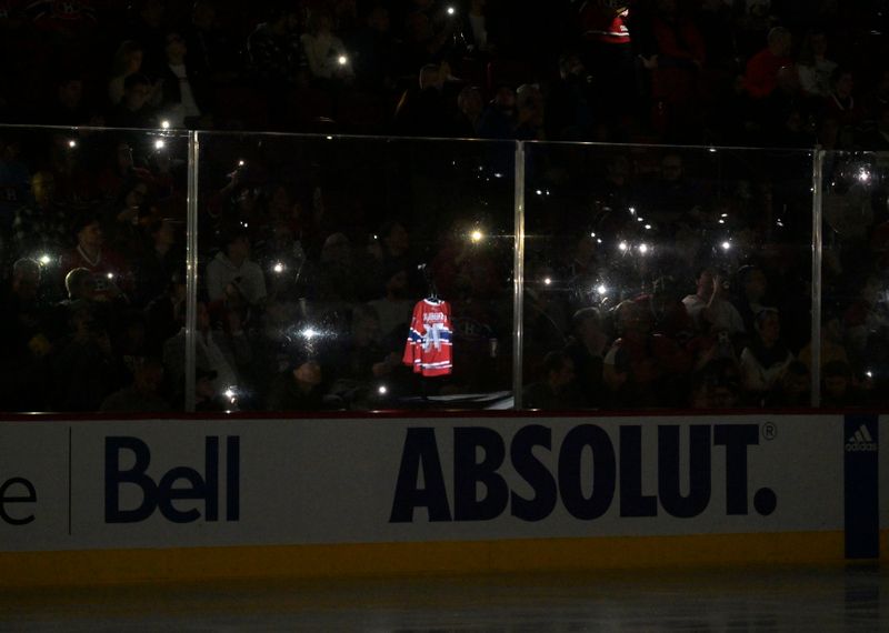 Nov 16, 2023; Montreal, Quebec, CAN; Reflection of a jersey during a moment of silence to commemorate musician Karl Tremblay before the game between the Vegas Golden Knights and the Montreal Canadiens at the Bell Centre. Mandatory Credit: Eric Bolte-USA TODAY Sports