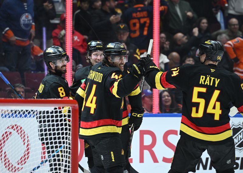 Oct 26, 2025; Vancouver, British Columbia, CAN; Vancouver Canucks left wing Kiefer Sherwood (44) celebrates the overtime win with team mates against the Edmonton Oilers  at Rogers Arena. Mandatory Credit: Simon Fearn-Imagn Images