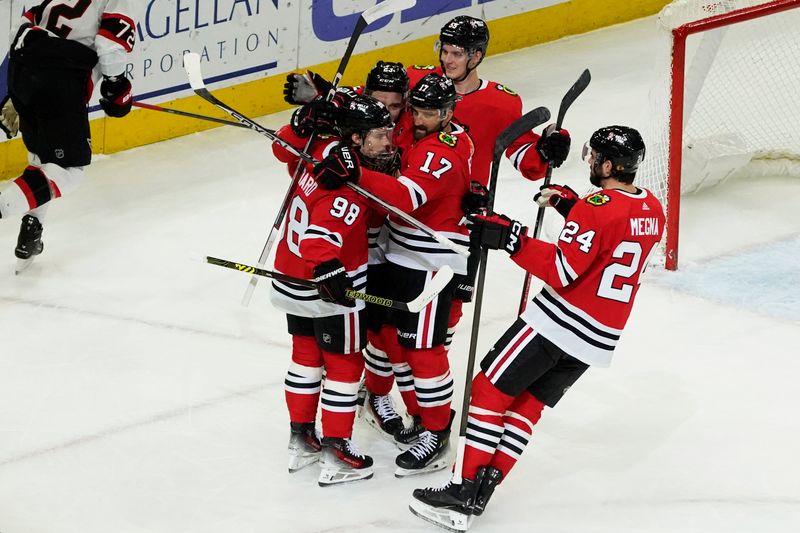 Feb 17, 2024; Chicago, Illinois, USA; Chicago Blackhawks left wing Nick Foligno (17) celebrates his goal with Chicago Blackhawks center Connor Bedard (98) against the Ottawa Senators during the first period at United Center. Mandatory Credit: David Banks-USA TODAY Sports