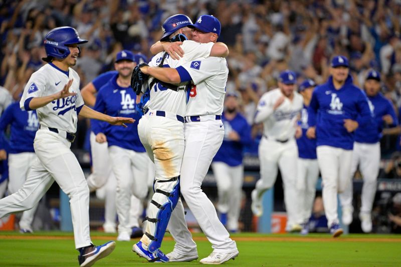 Oct 20, 2024; Los Angeles, California, USA; Los Angeles Dodgers pitcher Blake Treinen (49) celebrates with catcher Will Smith (16) after defeating the New York Mets in game six of the NLCS for the 2024 MLB playoffs at Dodger Stadium. Mandatory Credit: Jayne Kamin-Oncea-Imagn Images