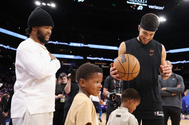 PHOENIX, ARIZONA - APRIL 28: Devin Booker #1 of the Phoenix Suns and  Arizona Cardinals quarterback Kyler Murray on the court before game four of the Western Conference First Round Playoffs against the Minnesota Timberwolves at Footprint Center on April 28, 2024 in Phoenix, Arizona. NOTE TO USER: User expressly acknowledges and agrees that, by downloading and or using this photograph, User is consenting to the terms and conditions of the Getty Images License Agreement.  (Photo by Christian Petersen/Getty Images)