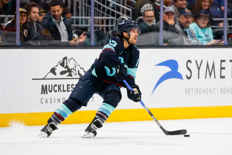 Feb 26, 2024; Seattle, Washington, USA; Seattle Kraken left wing Brandon Tanev (13) skates with the puck against the Boston Bruins during the first period at Climate Pledge Arena. Mandatory Credit: Joe Nicholson-USA TODAY Sports